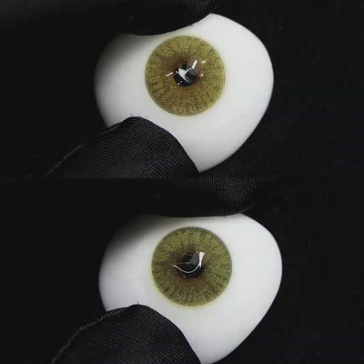 A simulated brown prosthetic eye showing the visual transformation effect of wearing Wooeye Mulberry Green colored contact lenses against a black background.