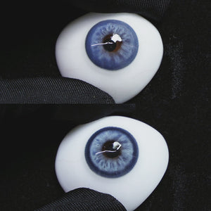 Mystery Blue contact lenses on a brown simulated eyeball with a black background