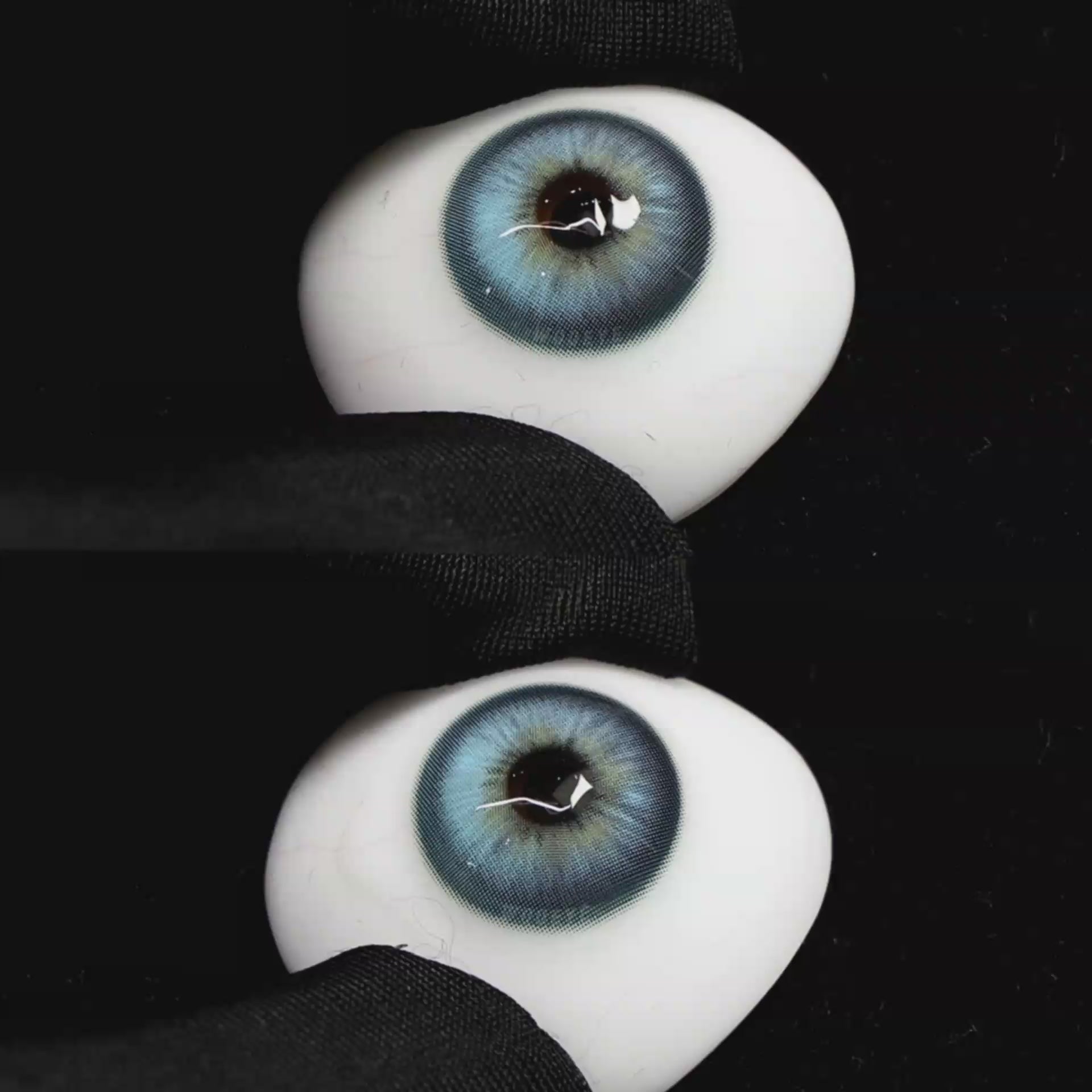 A simulated brown prosthetic eye showing the visual transformation effect of wearing Wooeye Casa Blue colored contact lenses against a black background.
