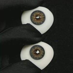 A simulated brown prosthetic eye showing the visual transformation effect of wearing Dancer Deep Blue colored contact lenses against a black background.