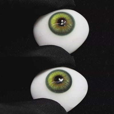 A simulated brown prosthetic eye showing the visual transformation effect of wearing Wooeye Casa Green colored contact lenses against a black background.