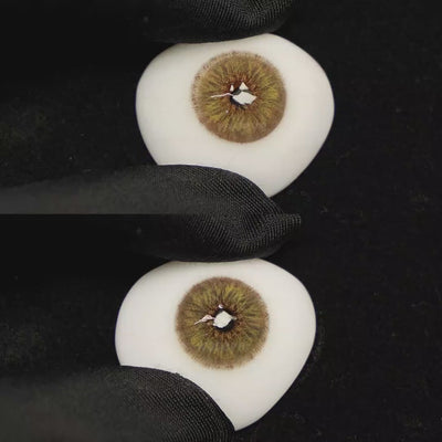 A simulated brown prosthetic eye showing the visual transformation effect of wearing Breeze Hazel Brown colored contact lenses against a black background.