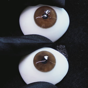 Master Grey contact lenses on a brown simulated eyeball with a black background