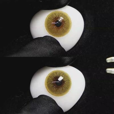 A simulated brown prosthetic eye showing the visual transformation effect of wearing Wooeye Queen Brown II colored contact lenses against a black background.