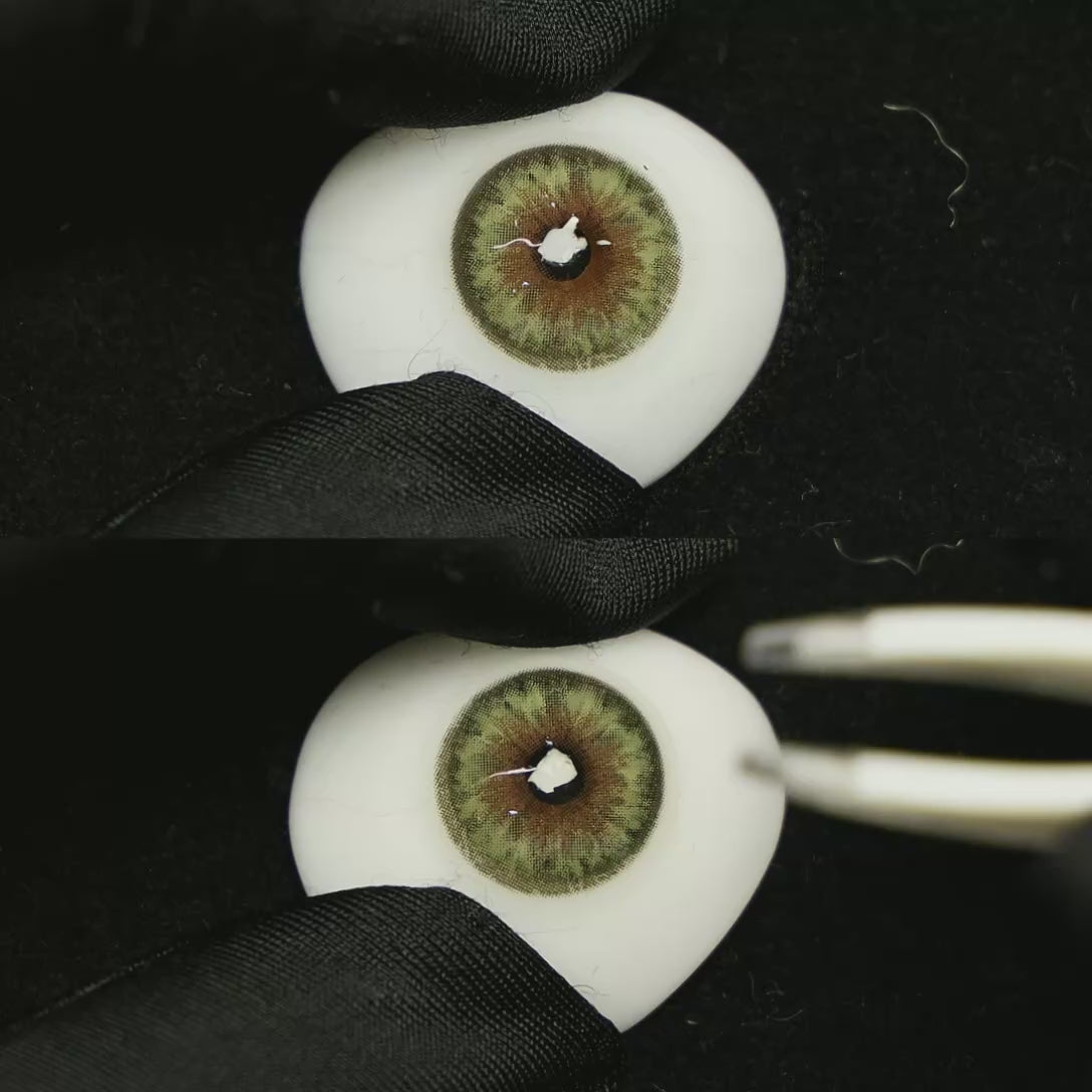 A simulated brown prosthetic eye showing the visual transformation effect of wearing Chamer Green colored contact lenses against a black background.