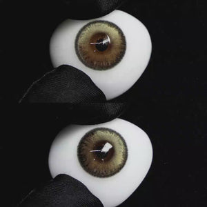 A simulated brown prosthetic eye showing the visual transformation effect of wearing Wooeye Bubbles Brown colored contact lenses against a black background.