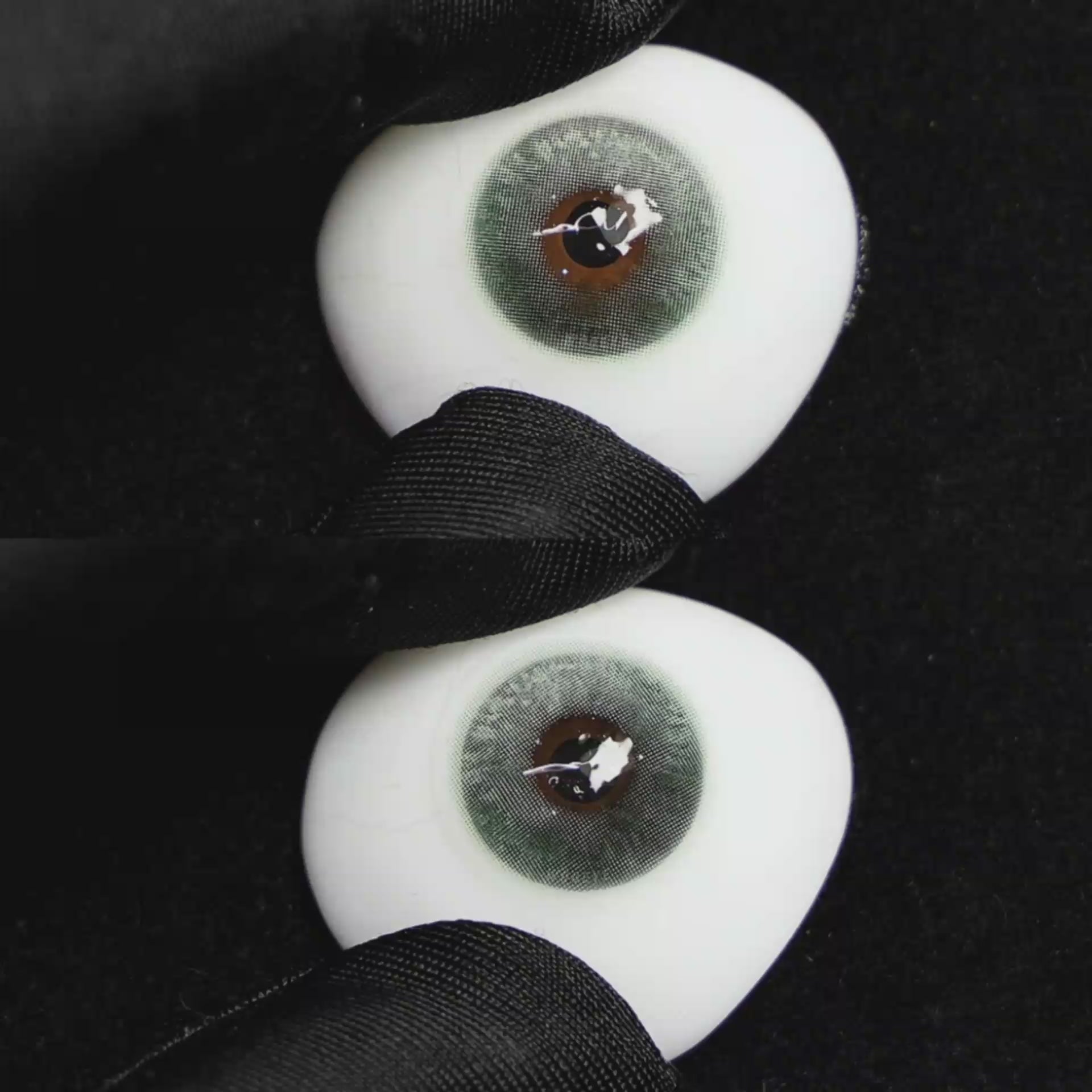 A simulated brown prosthetic eye showing the visual transformation effect of wearing Wooeye Clouds Green colored contact lenses against a black background.