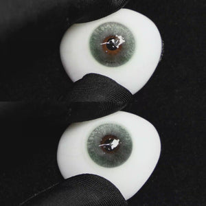 A simulated brown prosthetic eye showing the visual transformation effect of wearing Wooeye Clouds Green colored contact lenses against a black background.