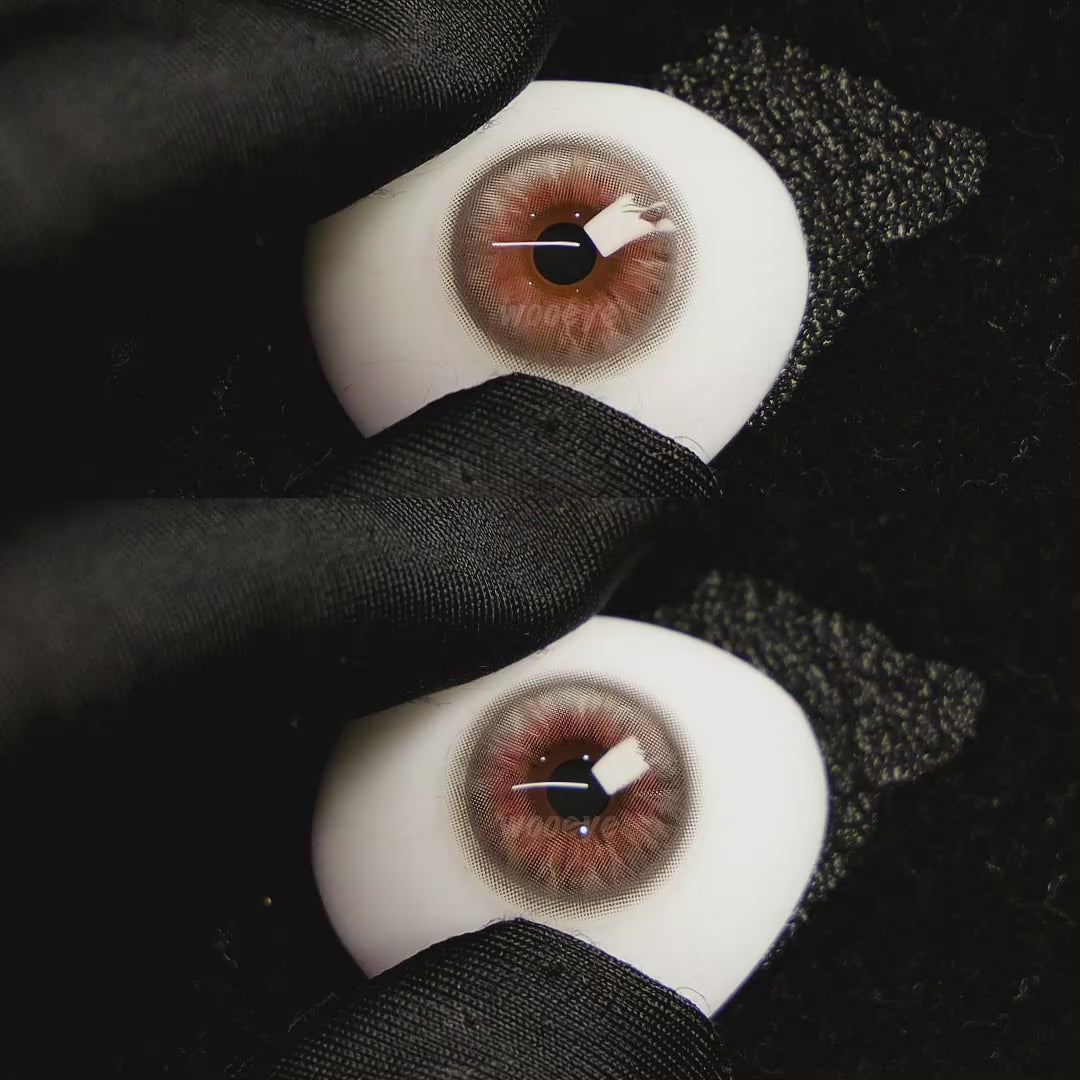 A simulated brown prosthetic eye showing the visual transformation effect of wearing Coral Grey colored contact lenses against a black background.