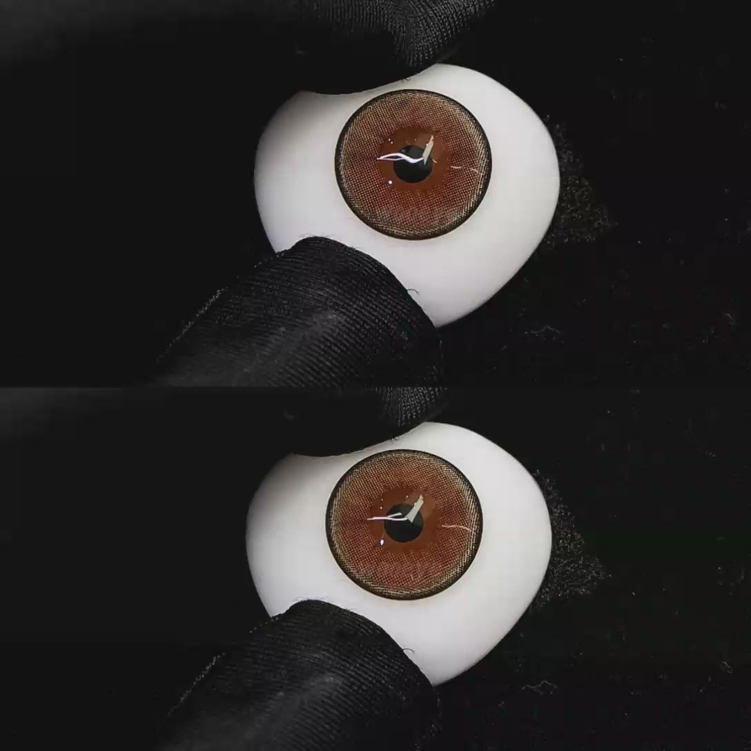 A simulated brown prosthetic eye showing the visual transformation effect of wearing Wooeye Moon Brown colored contact lenses against a black background.