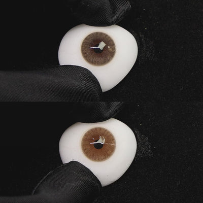 A simulated brown prosthetic eye showing the visual transformation effect of wearing mousse brown i colored contact lenses against a black background.