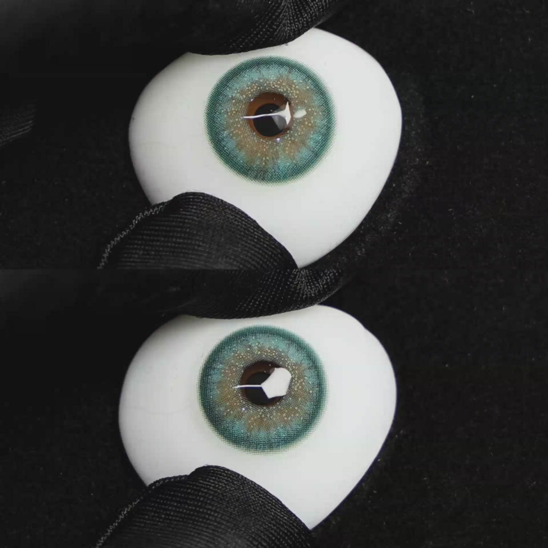 A simulated brown prosthetic eye showing the visual transformation effect of wearing Wooeye Star Green colored contact lenses against a black background.