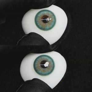A simulated brown prosthetic eye showing the visual transformation effect of wearing Wooeye Star Green colored contact lenses against a black background.