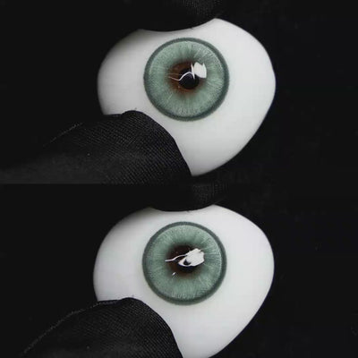 A simulated brown prosthetic eye showing the visual transformation effect of wearing Wooeye Boston Green colored contact lenses against a black background.