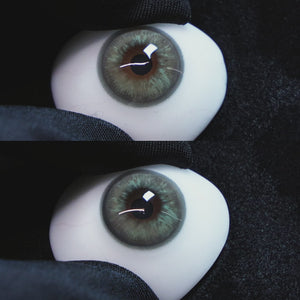 Mystery Gray contact lenses on a brown simulated eyeball with a black background