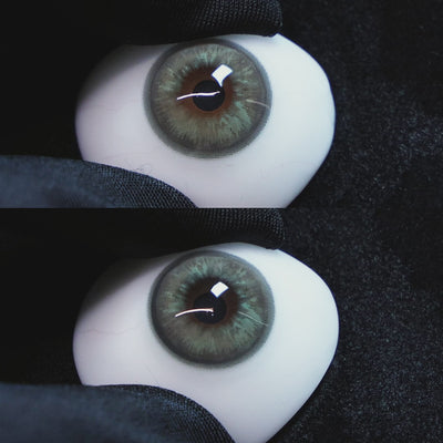 Mystery Gray contact lenses on a brown simulated eyeball with a black background