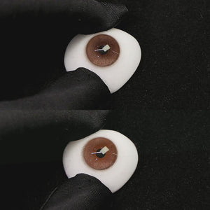 A simulated brown prosthetic eye showing the visual transformation effect of wearing princess coffe brown colored contact lenses against a black background.