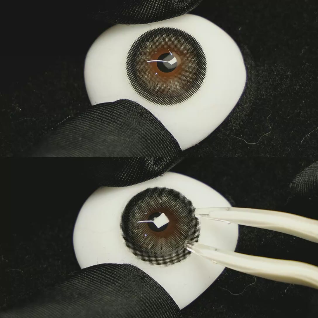 A simulated brown prosthetic eye showing the visual transformation effect of wearing Acorn Amber Grey colored contact lenses against a black background.