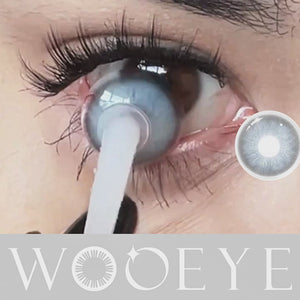 Woman blinks after wearing Lrish Blue contact lens