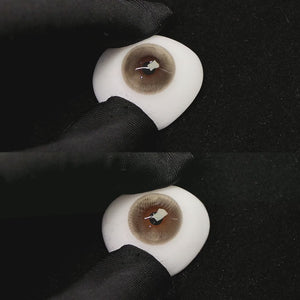 A simulated brown prosthetic eye showing the visual transformation effect of wearing princess gray colored contact lenses against a black background.