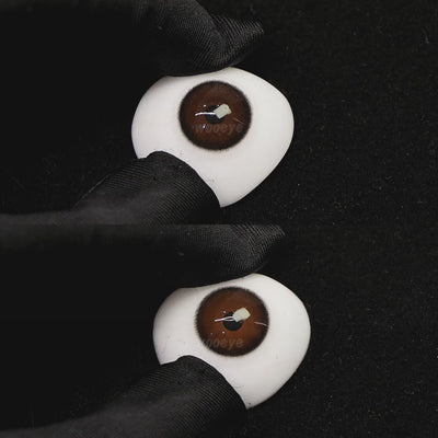 A simulated brown prosthetic eye showing the visual transformation effect of wearing black coffee brown colored contact lenses against a black background.