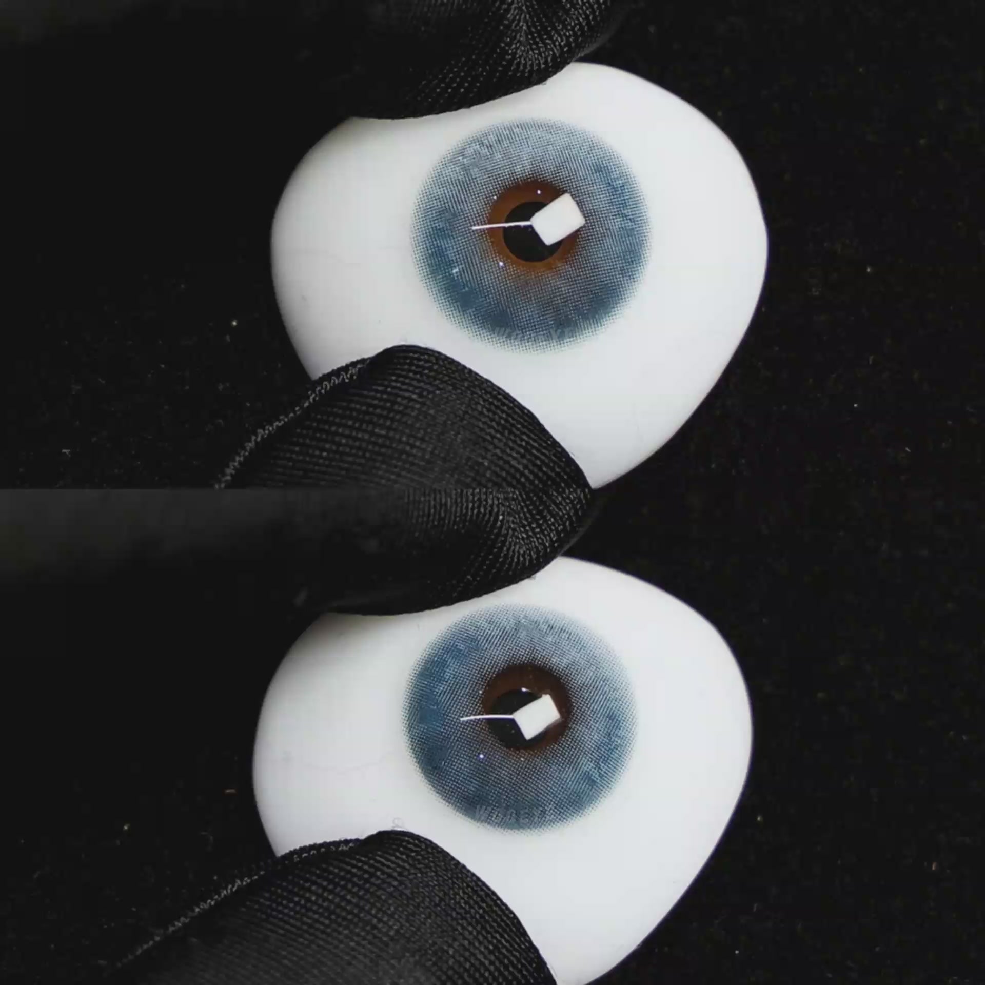 A simulated brown prosthetic eye showing the visual transformation effect of wearing Wooeye Clouds Blue colored contact lenses against a black background.