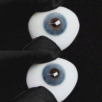 A simulated brown prosthetic eye showing the visual transformation effect of wearing Wooeye Clouds Blue colored contact lenses against a black background.
