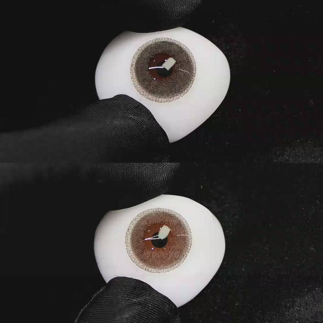 A simulated brown prosthetic eye showing the visual transformation effect of wearing Wooeye Cream Brown I colored contact lenses against a black background.