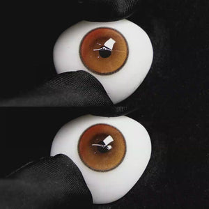 A simulated brown prosthetic eye showing the visual transformation effect of wearing Wooeye Soul Pink colored contact lenses against a black background.