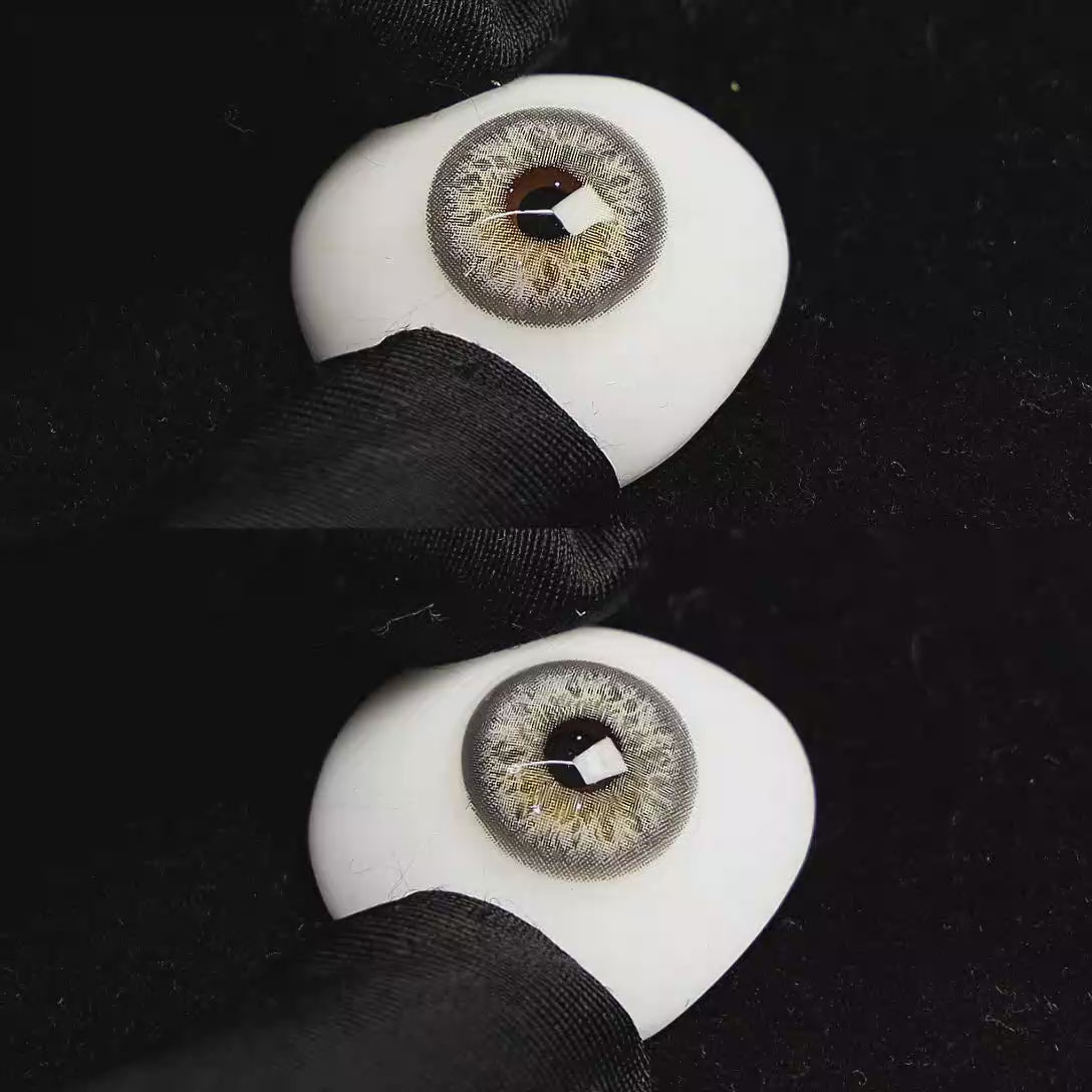A simulated brown prosthetic eye showing the visual transformation effect of wearing Sequoia Blue colored contact lenses against a black background.