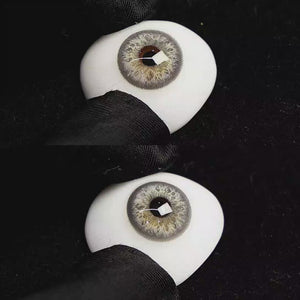 A simulated brown prosthetic eye showing the visual transformation effect of wearing Sequoia Blue colored contact lenses against a black background.