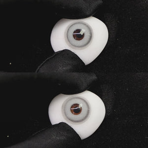 A simulated brown prosthetic eye showing the visual transformation effect of wearing princess gray i colored contact lenses against a black background.