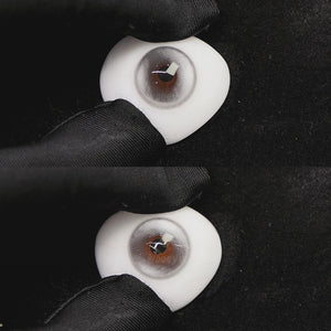 A simulated brown prosthetic eye showing the visual transformation effect of wearing halo pro silver colored contact lenses against a black background.