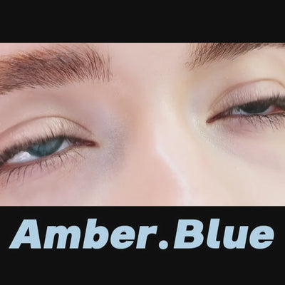 Woman winks while wearing amber blue contact lenses