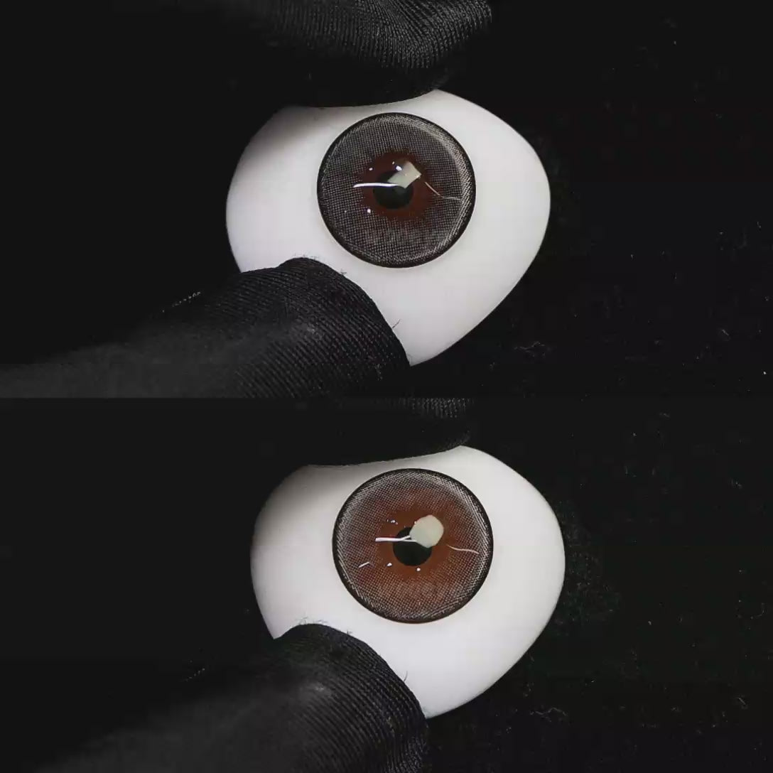 A simulated brown prosthetic eye showing the visual transformation effect of wearing Wooeye Moon Gray colored contact lenses against a black background.