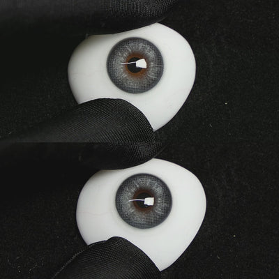 A simulated brown prosthetic eye showing the visual transformation effect of wearing Wooeye Frozen Blue colored contact lenses against a black background.