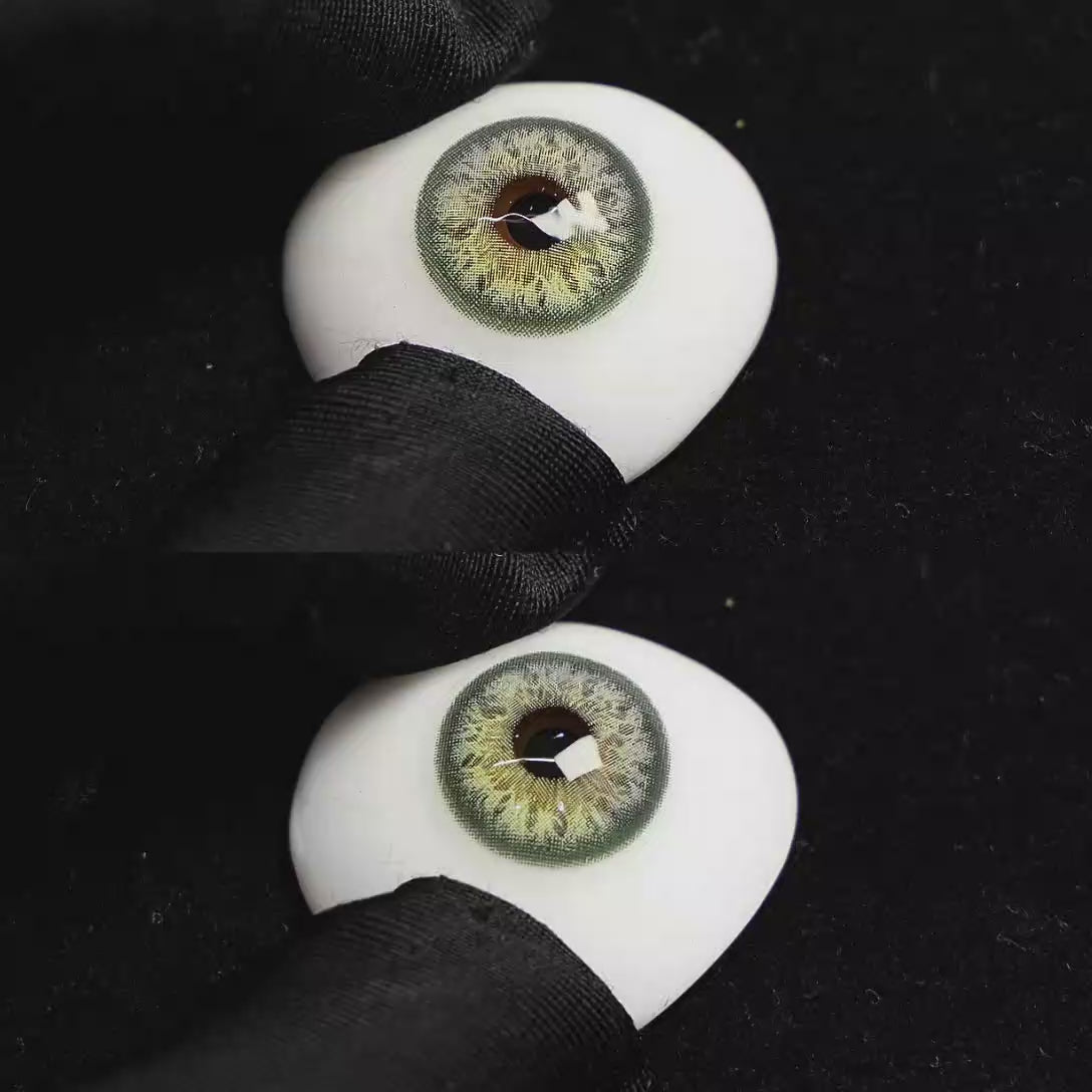 A simulated brown prosthetic eye showing the visual transformation effect of wearing Sequoia Green colored contact lenses against a black background.