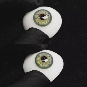 A simulated brown prosthetic eye showing the visual transformation effect of wearing Sequoia Green colored contact lenses against a black background.