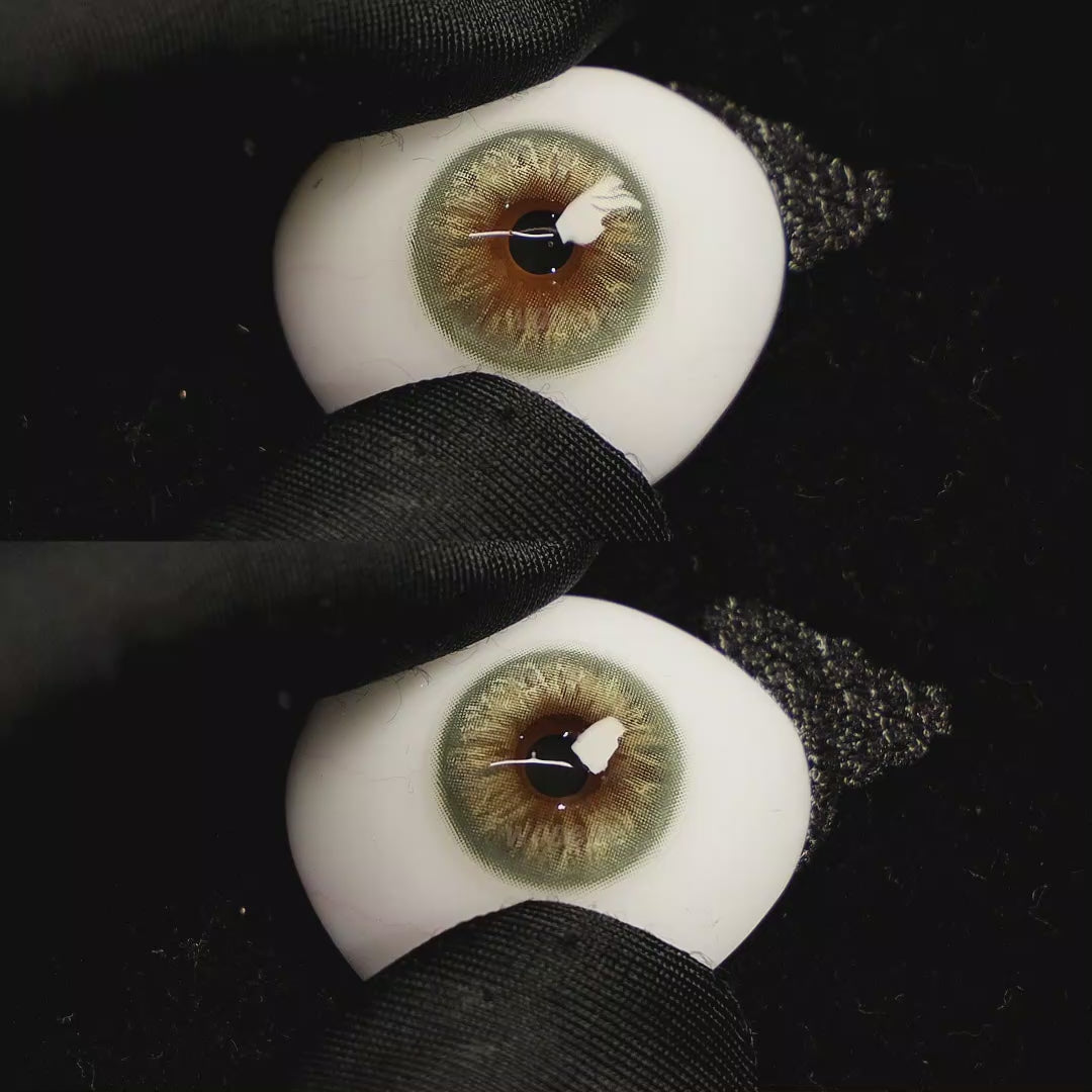 A simulated brown prosthetic eye showing the visual transformation effect of wearing Velvet Green colored contact lenses against a black background.