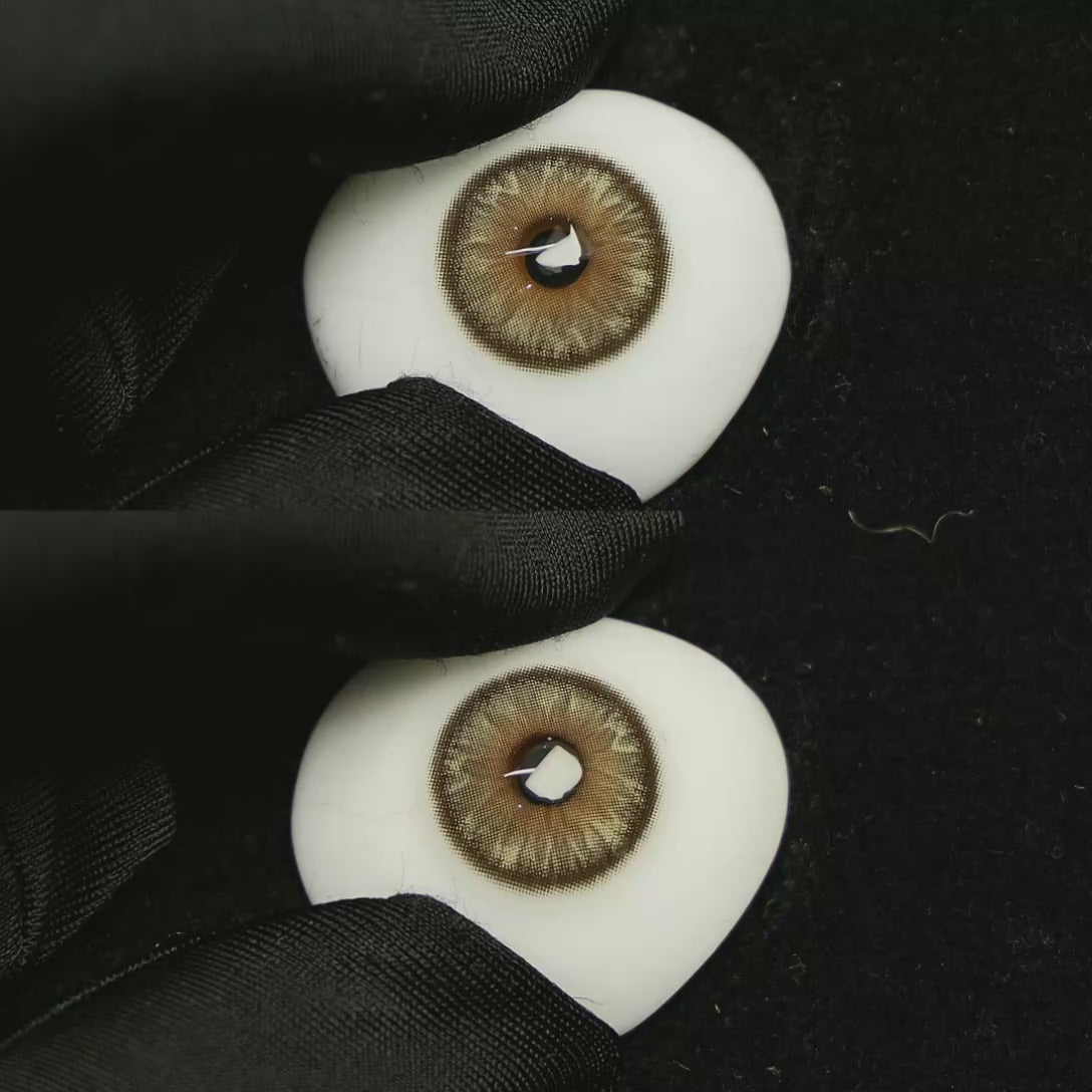 A simulated brown prosthetic eye showing the visual transformation effect of wearing Space Brown colored contact lenses against a black background.