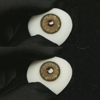 A simulated brown prosthetic eye showing the visual transformation effect of wearing Space Brown colored contact lenses against a black background.