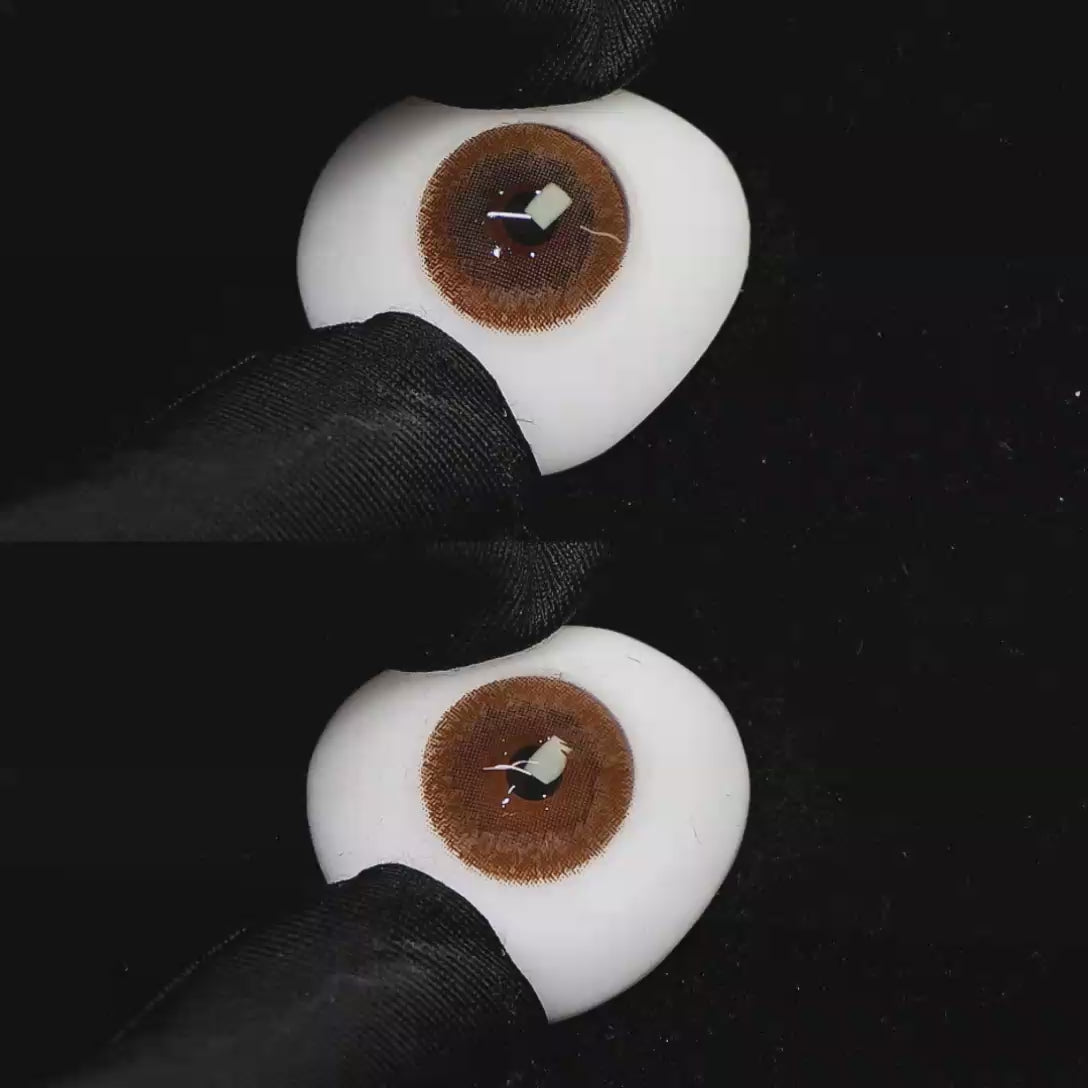 A simulated brown prosthetic eye showing the visual transformation effect of wearing Wooeye Freedom Brown colored contact lenses against a black background.