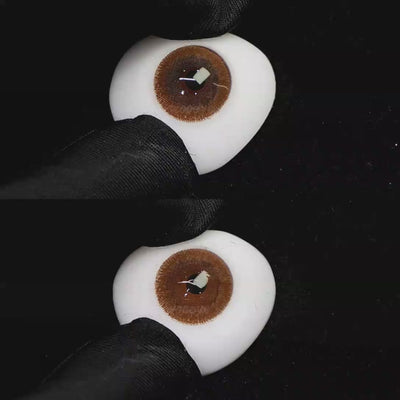 A simulated brown prosthetic eye showing the visual transformation effect of wearing Wooeye Freedom Brown colored contact lenses against a black background.