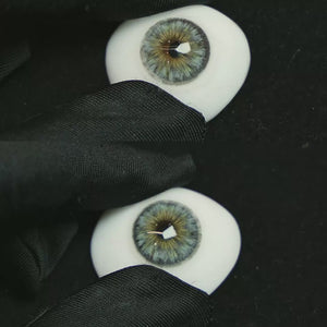 A simulated brown prosthetic eye showing the visual transformation effect of wearing Thorn Blue colored contact lenses against a black background.