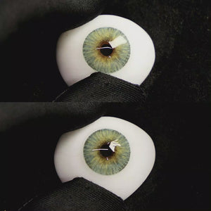 A simulated brown prosthetic eye showing the visual transformation effect of wearing Mist Green colored contact lenses against a black background.