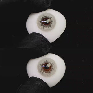 A simulated brown prosthetic eye showing the visual transformation effect of wearing Wooeye Creamy Beige Gray colored contact lenses against a black background.