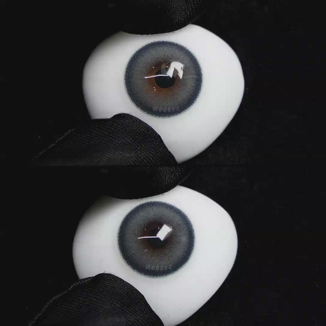 A simulated brown prosthetic eye showing the visual transformation effect of wearing Wooeye Charm Blue colored contact lenses against a black background.