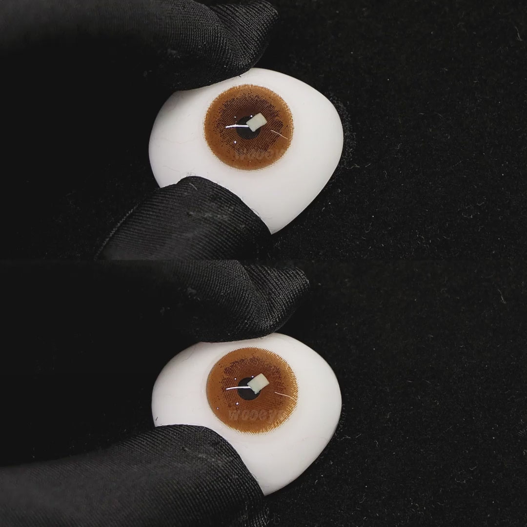 A simulated brown prosthetic eye showing the visual transformation effect of wearing coffee brown colored contact lenses against a black background.