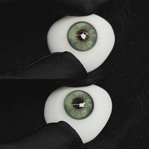 A simulated brown prosthetic eye showing the visual transformation effect of wearing Wooeye Frozen Green colored contact lenses against a black background.