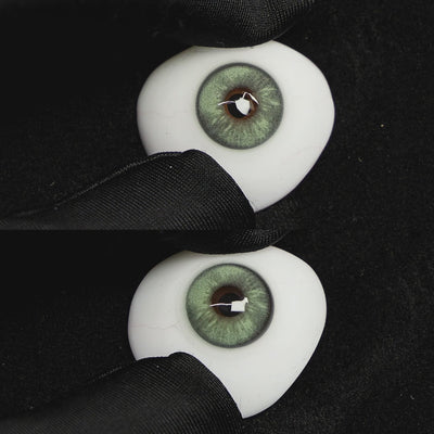 A simulated brown prosthetic eye showing the visual transformation effect of wearing Wooeye Frozen Green colored contact lenses against a black background.